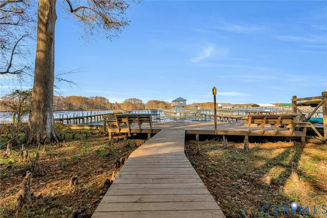 a view of a lake with boats and trees in the background
