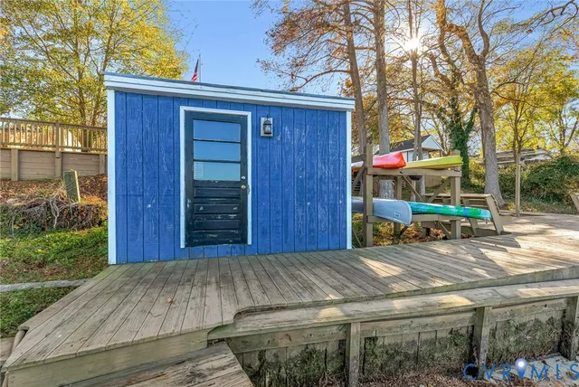a view of a house with a wooden fence