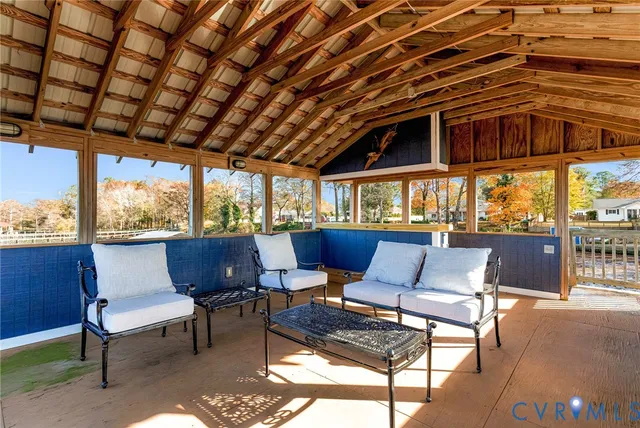a outdoor sitting area with furniture and wooden floor