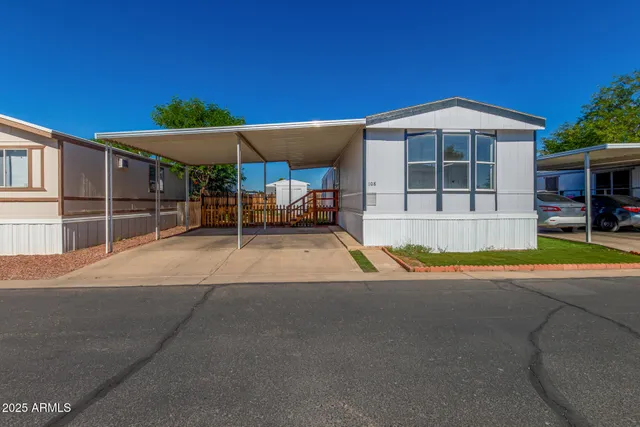 a view of a house with a swimming pool and sitting area