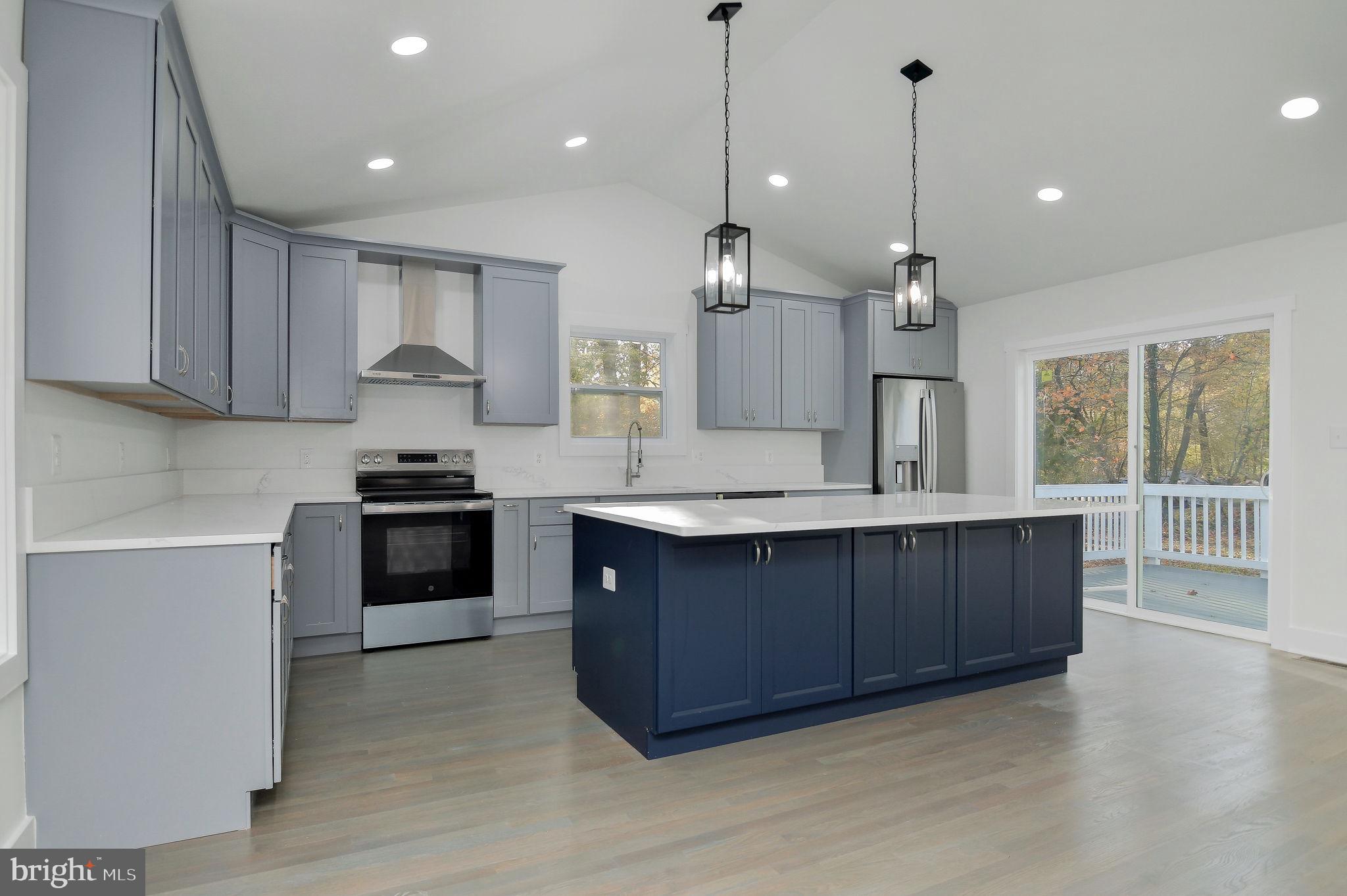 2016 Spring Grove Drive Accokeek, MD 20607 - Photo 11 of 36 a kitchen with stainless steel appliances granite countertop a sink a stove and a wooden floors