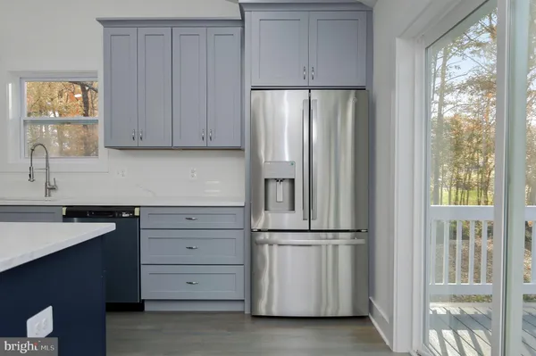 a kitchen with cabinets and a refrigerator