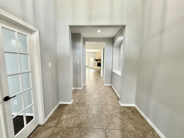 a view of empty room with a fireplace and windows