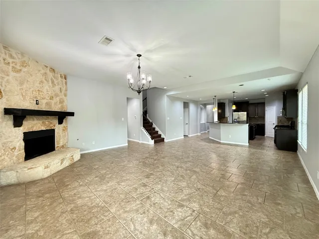 a view of a kitchen with a sink and a fireplace