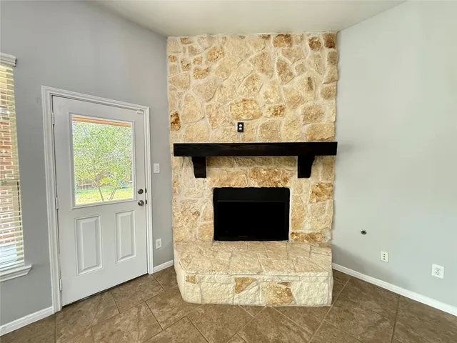 a living room with a fireplace and a window