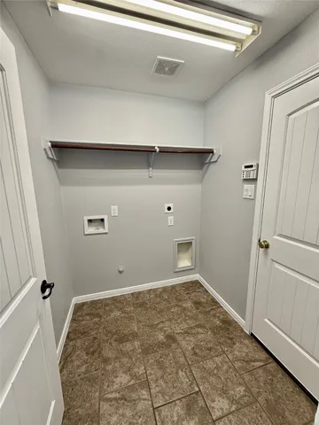 a large kitchen with stainless steel appliances granite countertop a stove a sink and a microwave