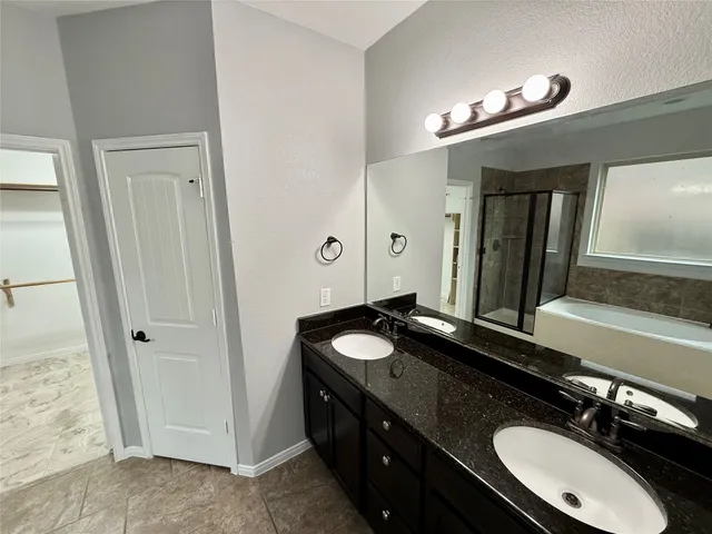 a bathroom with a bathtub and a shower