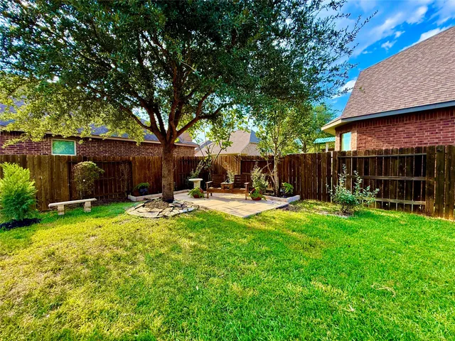 a view of backyard with hardwood floor and outdoor seating