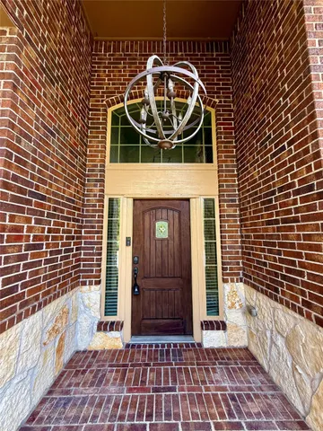 a view of a door and brick wall