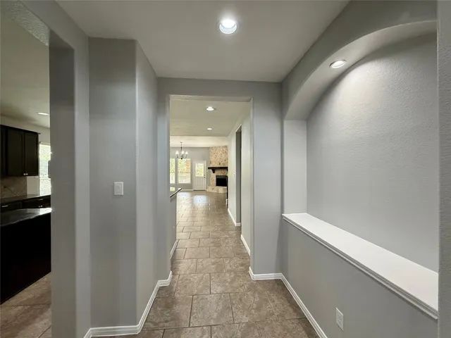 a view of a hallway with a dining table chair