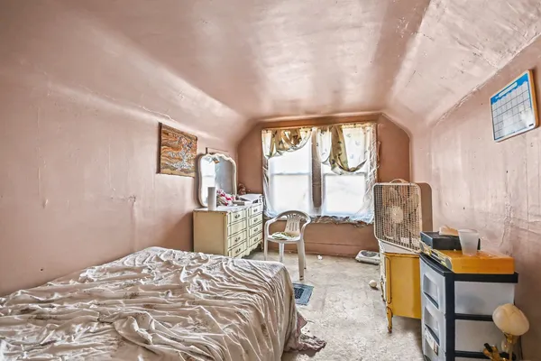a bedroom with furniture and a window