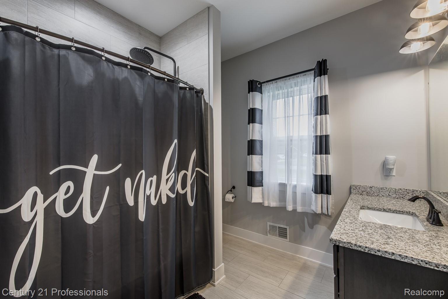4914 TORATOLA Lane Howell, MI 48843 - Photo 19 of 39 Full bathroom featuring vanity and curtained shower
