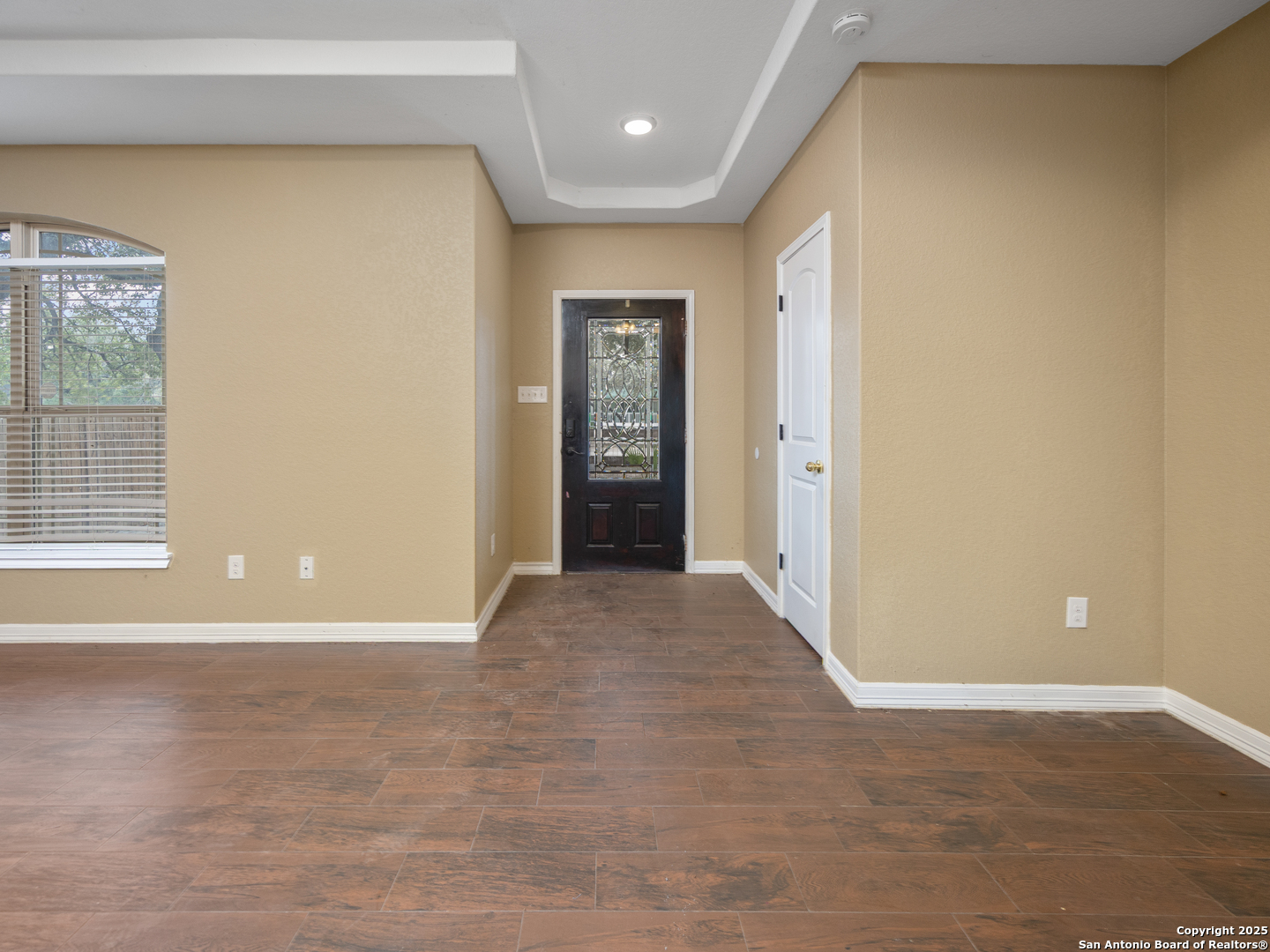 104 Viewpoint Drive Poteet, TX 78065 - Photo 3 of 23 a view of an empty room with window and wooden floor