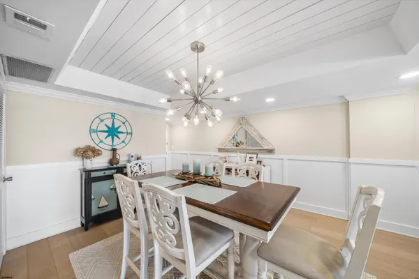 a view of a dining room with furniture and chandelier