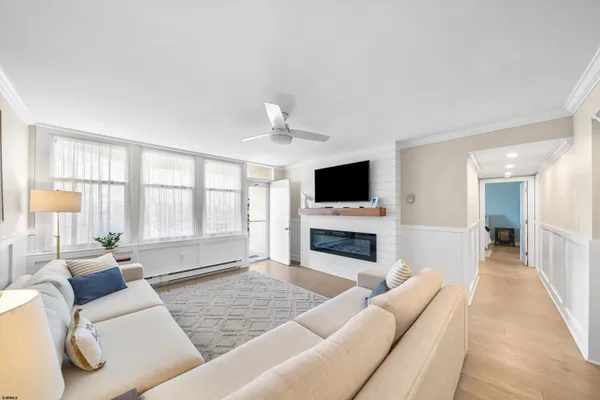 a living room with furniture fireplace and flat screen tv