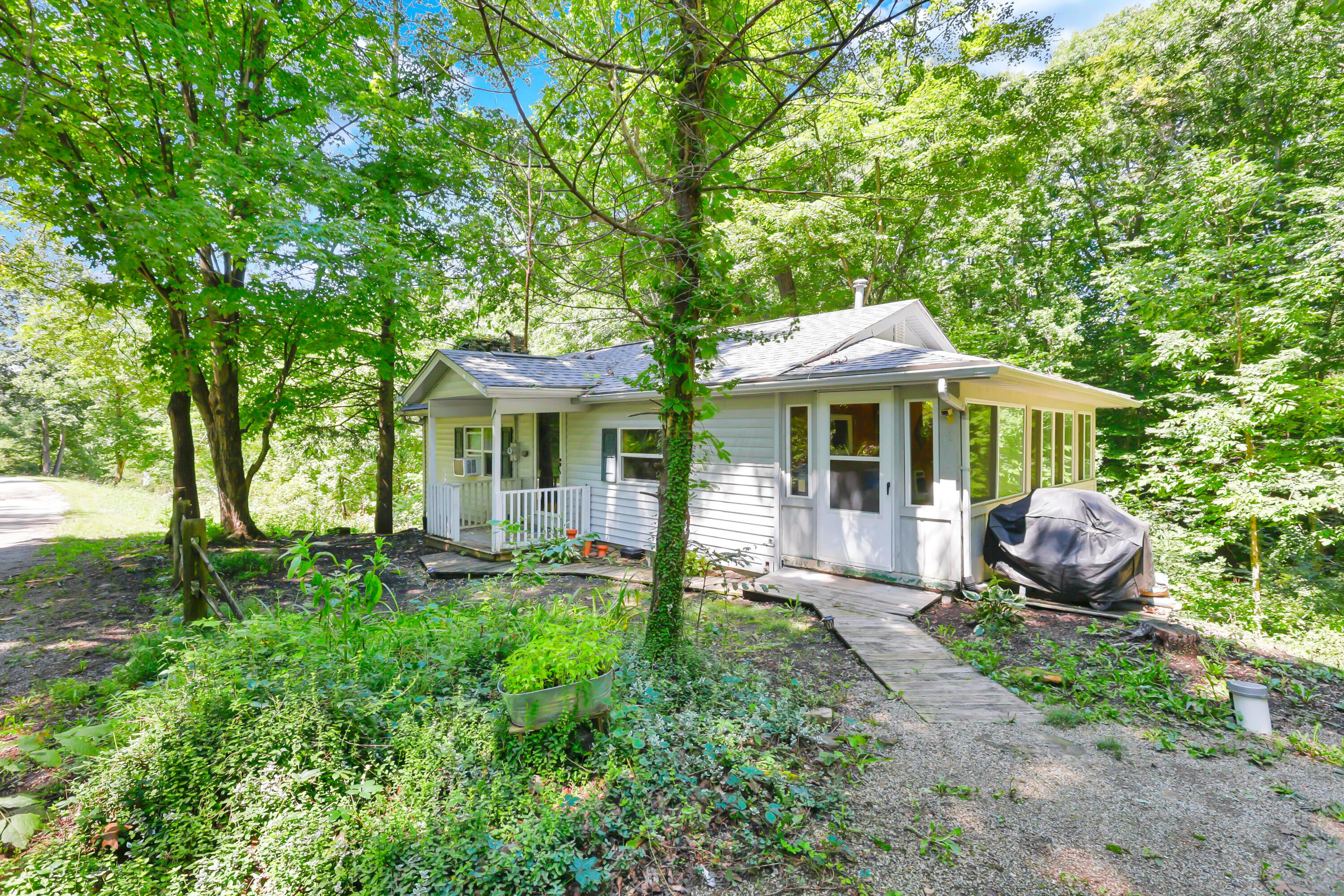 9126 Walnut Dowler Road Logan, OH 43138 - Photo 2 of 41 Siding exterior with a covered porch and an enclosed sunroom