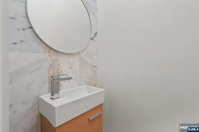 a bathroom with a sink a mirror and vanity