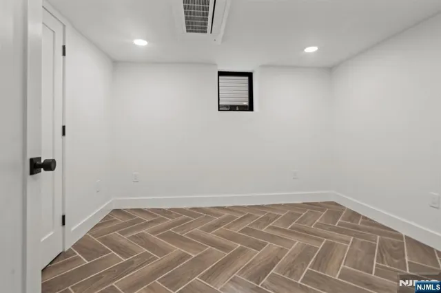 a view of a room with wooden floor
