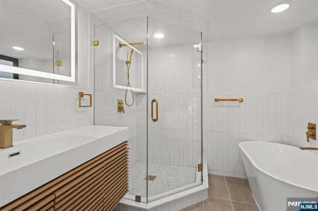 a bathroom with a bathtub and a shower