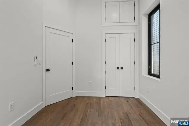 a view of an empty room with closet area