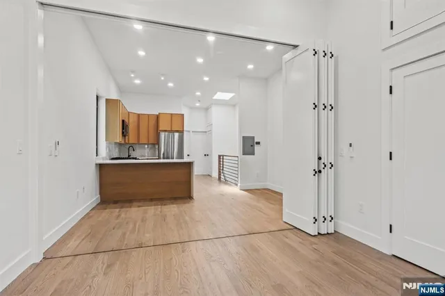 a view of kitchen with refrigerator and window