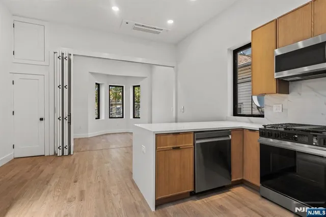 a kitchen with stainless steel appliances granite countertop a stove and a sink