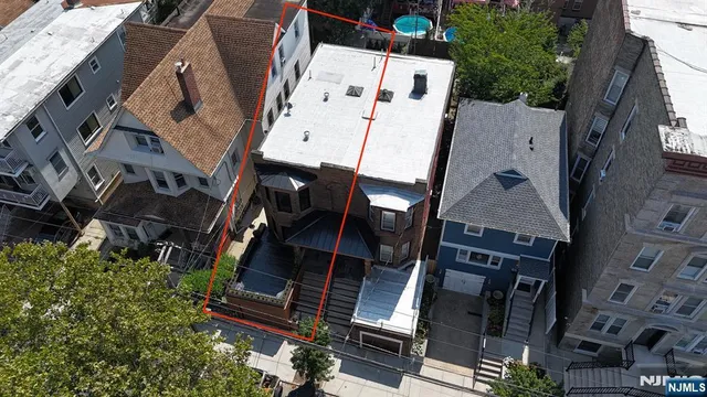 an aerial view of residential house with parking