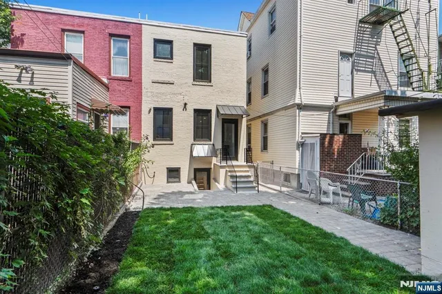 a view of a patio with a table and chairs under an umbrella