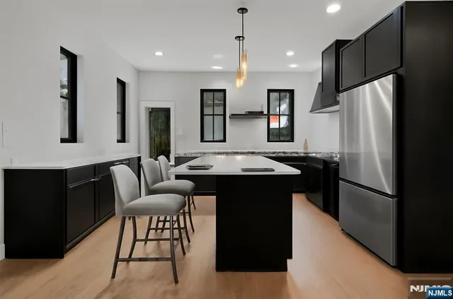 a kitchen with a refrigerator and a sink