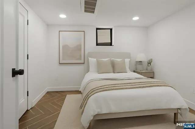 a bedroom with a bed and a painting