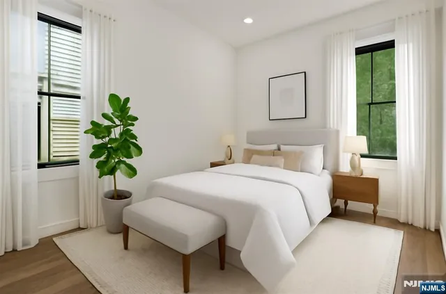 a bedroom with a bed and a potted plant