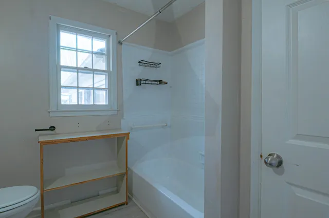 a bathroom with a bathtub and toilet