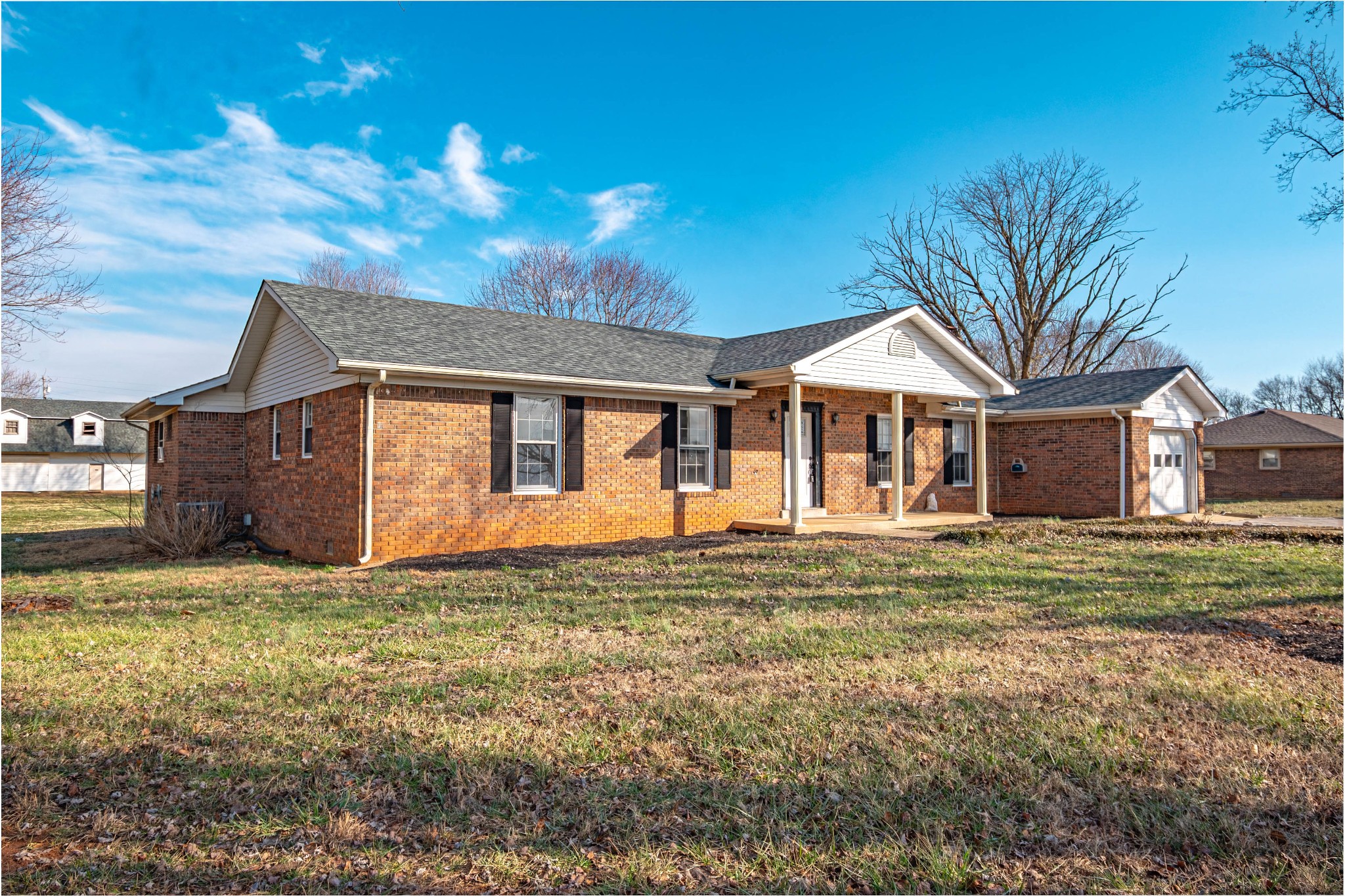 674 Girkin Road Bowling Green, KY 42101 - Photo 4 of 50 a large house with a big yard and large trees
