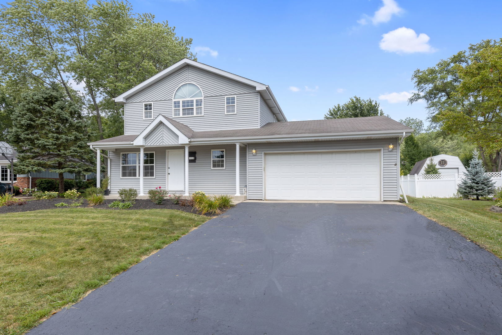 600 Stonegate Road New Lenox, IL 60451 - Photo 2 of 23 a front view of a house with a yard and garage