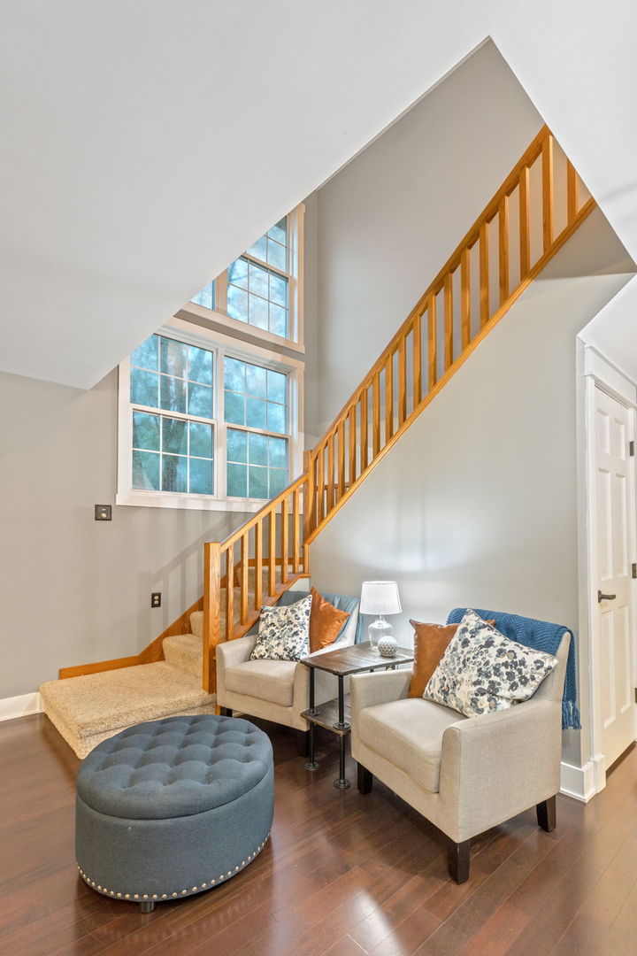 600 Stonegate Road New Lenox, IL 60451 - Photo 11 of 23 a living room with couches and a dining table with wooden floor