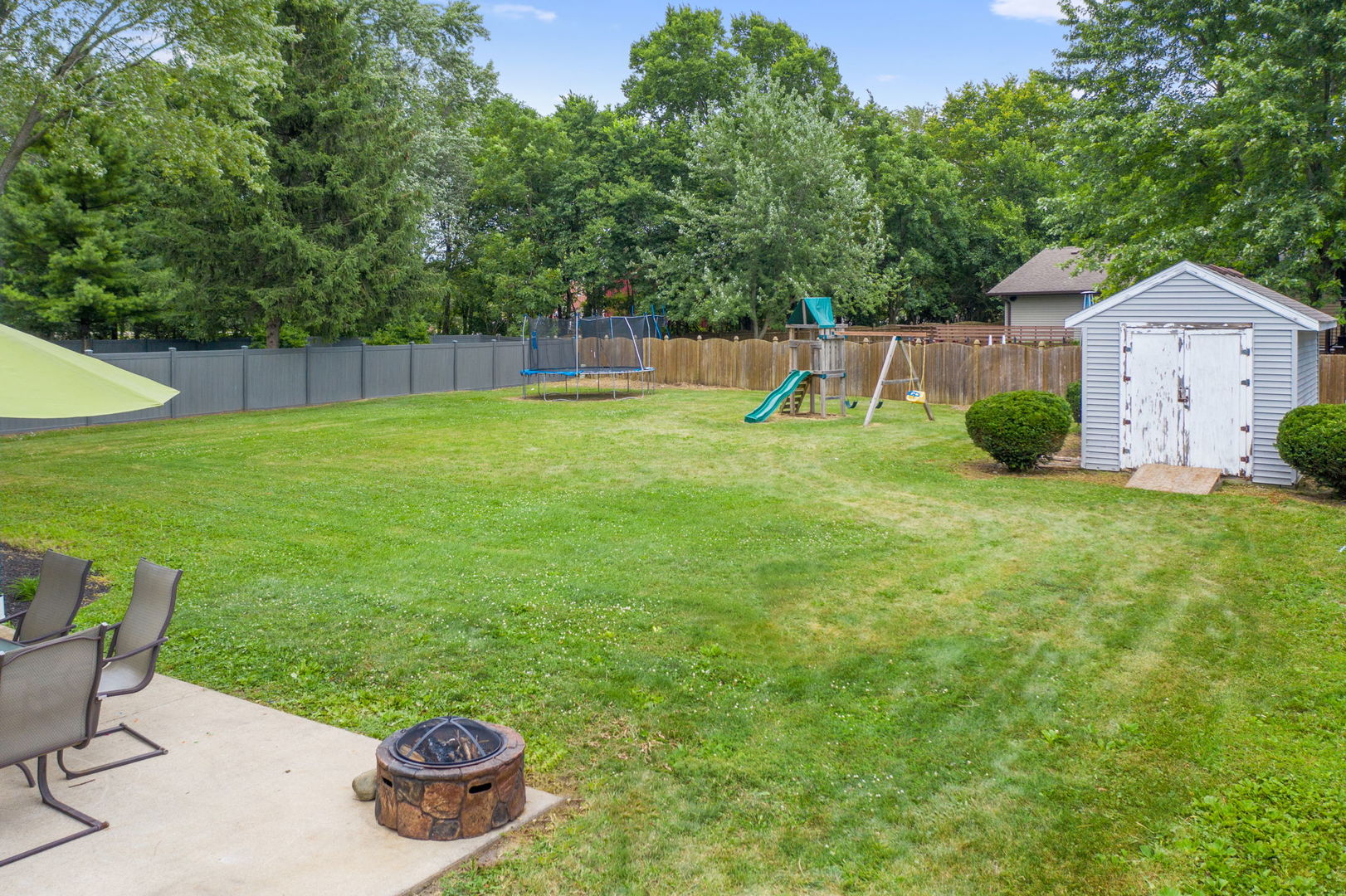600 Stonegate Road New Lenox, IL 60451 - Photo 23 of 23 a view of a backyard with table and chairs and wooden fence