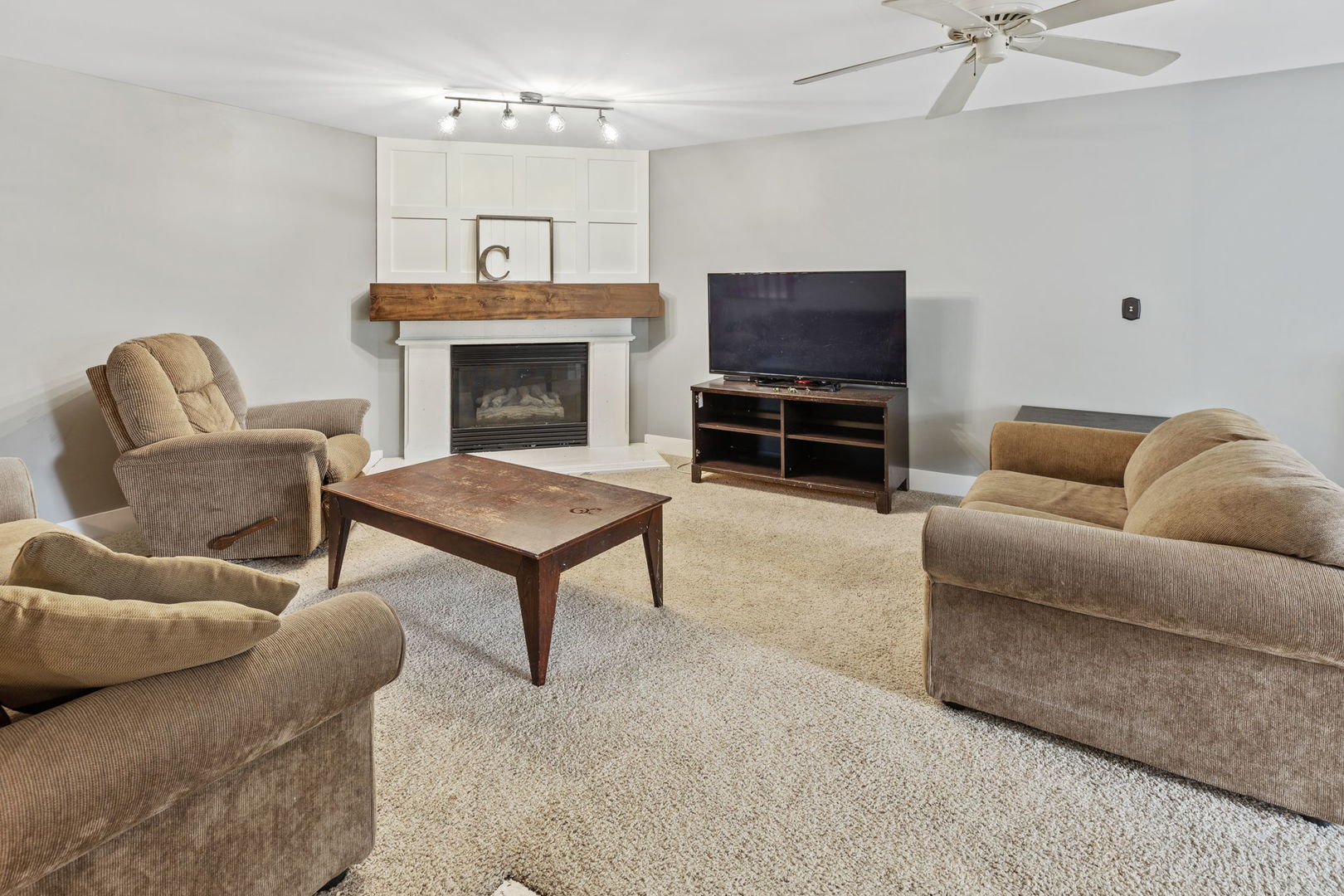600 Stonegate Road New Lenox, IL 60451 - Photo 8 of 23 a living room with furniture a flat screen tv and a fireplace
