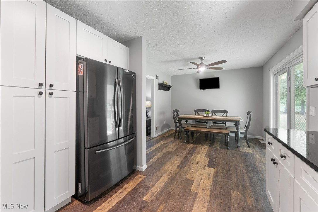 1761 Rustic Run Road Warren, OH 44481 - Photo 17 of 45 Kitchen with freestanding refrigerator, white cabinets, dark wood-style floors, a textured ceiling, and ceiling fan