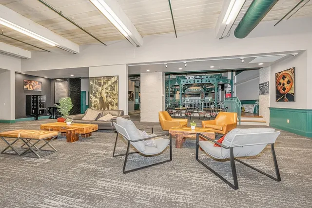 a living room with patio furniture and a floor to ceiling window