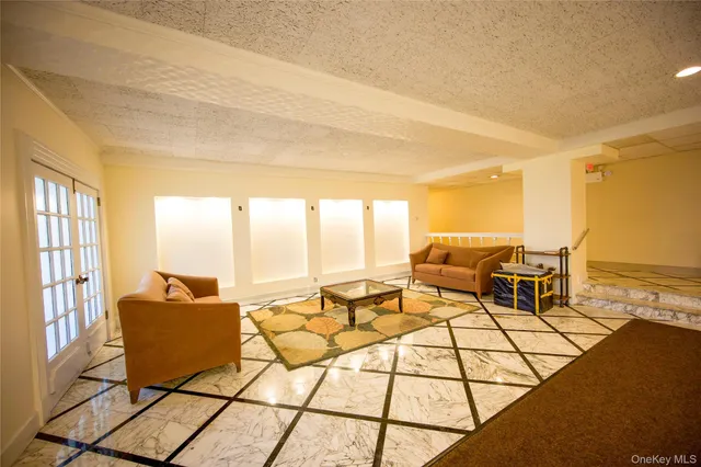 a living room with furniture and floor to ceiling window