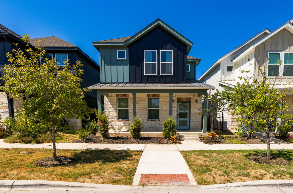Craftsman architectural elements highlight the front exterior, accented by stone masonry and a welcoming porch.