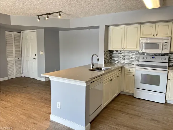 a kitchen with a stove oven and sink