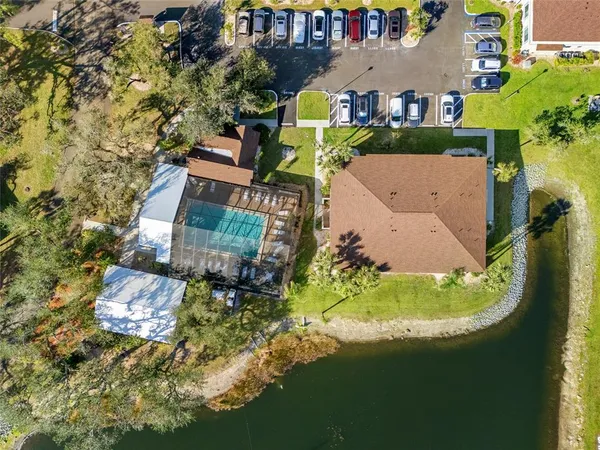 an aerial view of a house with a garden and swimming pool