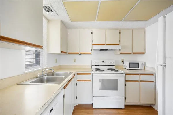 a kitchen with a sink stove and cabinets