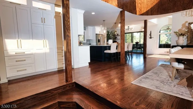 a view of dining room with kitchen island sink refrigerator and fireplace