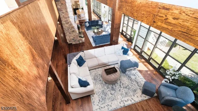 a living room with furniture and a floor to ceiling window