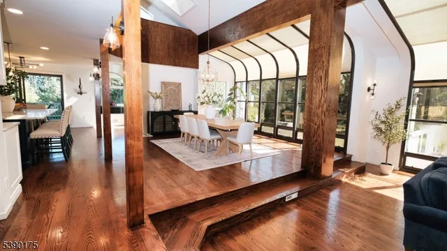a living room with stainless steel appliances kitchen island granite countertop furniture a rug and a view of kitchen
