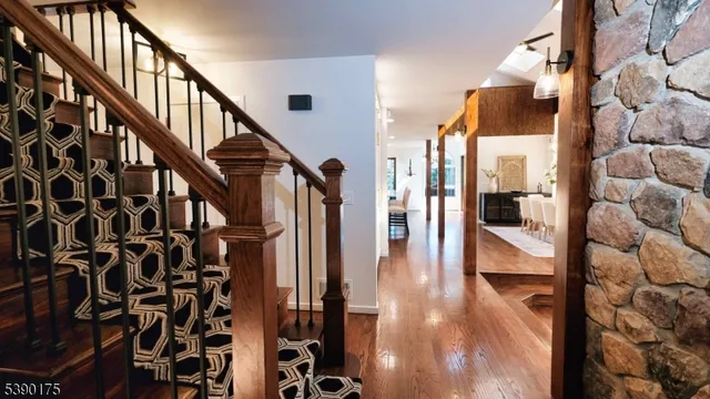 a view of entryway and hall with wooden floor