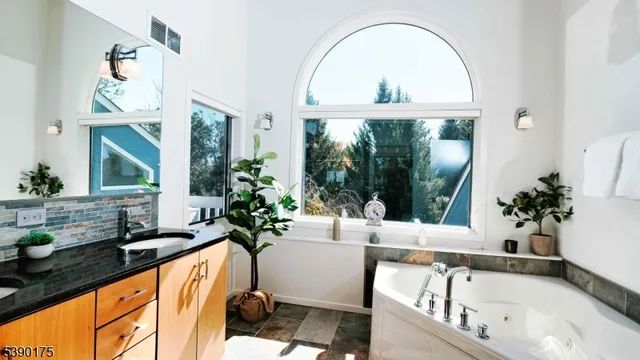 a very nice looking room with a large window and potted plants