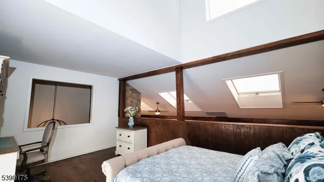 a bedroom with a bed and a large mirror